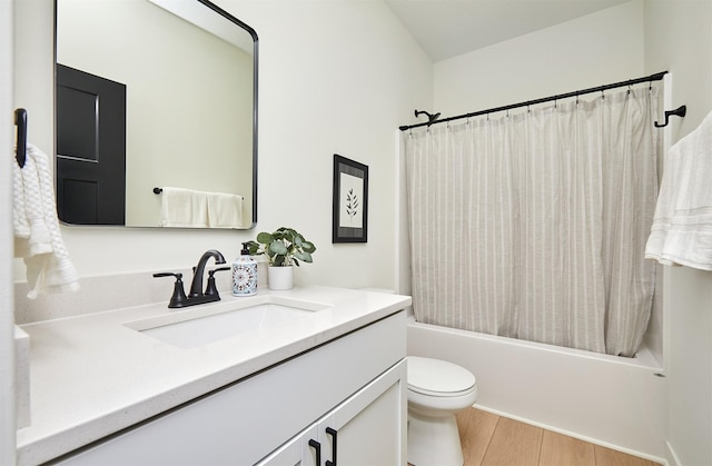 bathroom featuring shower / tub combo, toilet, wood finished floors, and vanity