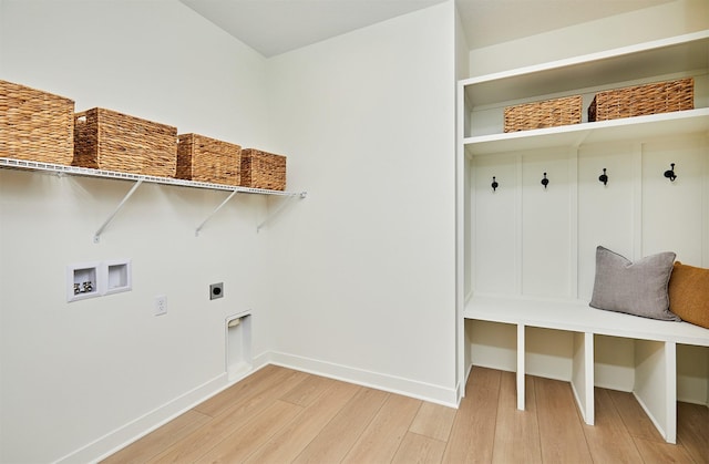 interior space with baseboards and light wood finished floors