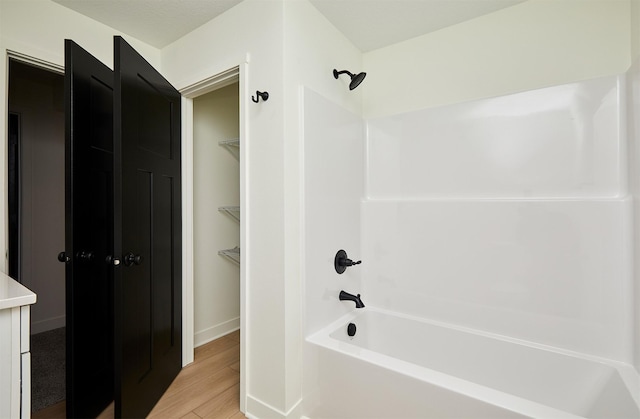 full bath featuring shower / tub combination and wood finished floors