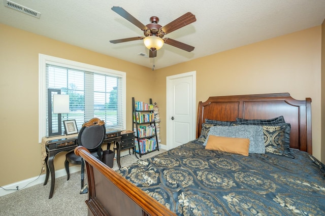 bedroom with light carpet, visible vents, ceiling fan, and baseboards