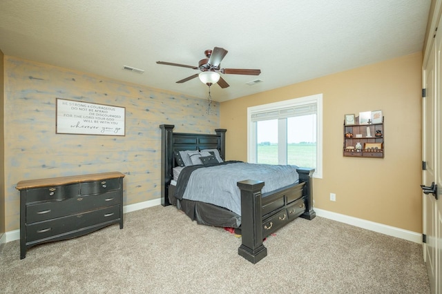 bedroom with visible vents, baseboards, carpet, and wallpapered walls