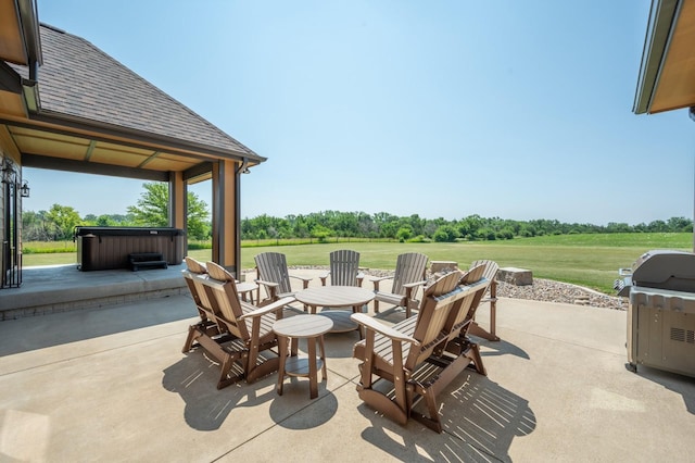 view of patio featuring grilling area and a hot tub