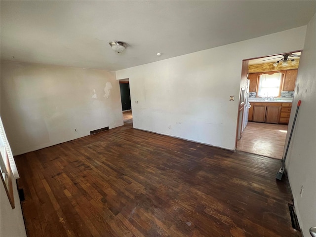 empty room featuring hardwood / wood-style floors and a sink