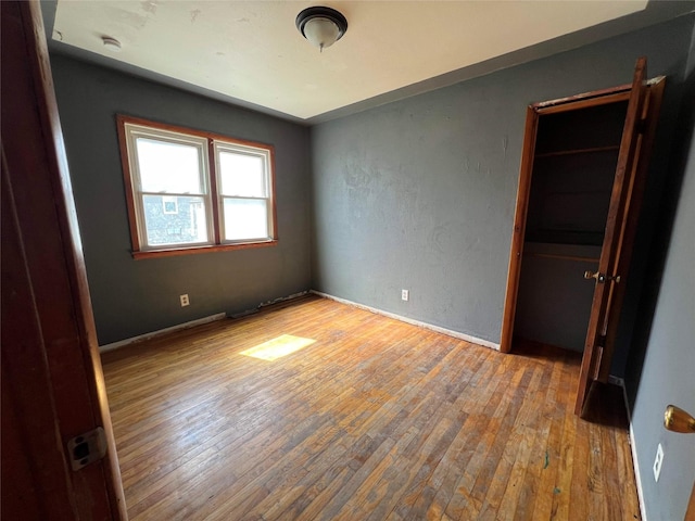 unfurnished bedroom with wood-type flooring