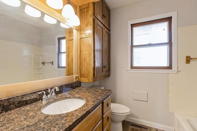 full bathroom featuring visible vents, baseboards, toilet, vanity, and a shower