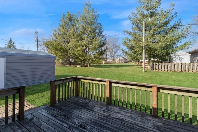 wooden deck featuring a yard and fence