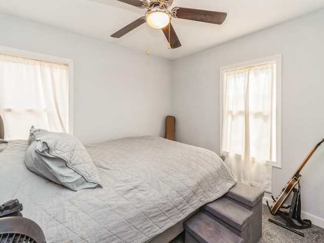 bedroom with a ceiling fan, carpet, and baseboards