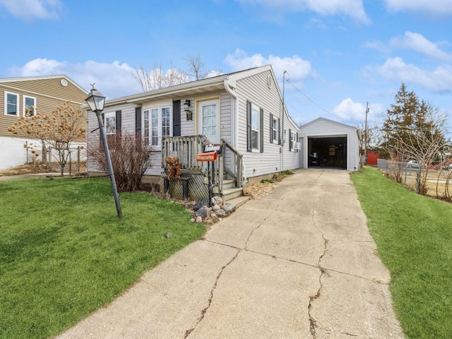 view of front of property featuring a front yard, concrete driveway, an outbuilding, and a detached garage