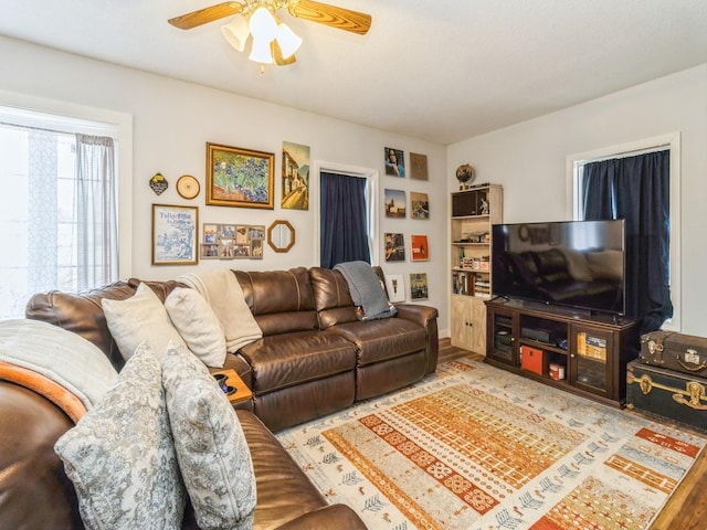 living room with ceiling fan and wood finished floors