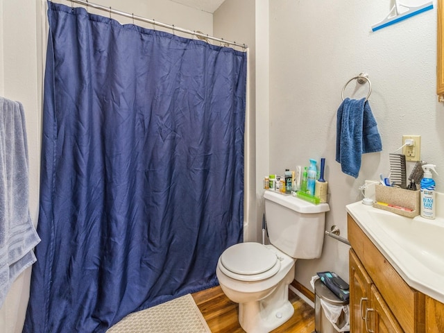 full bathroom with a shower with curtain, toilet, wood finished floors, and vanity