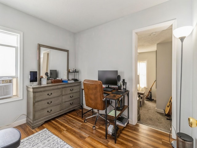 home office with baseboards and wood finished floors