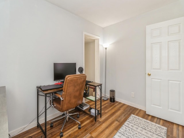 home office featuring wood finished floors and baseboards