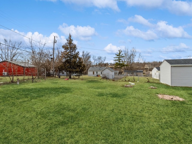 view of yard with an outdoor structure and fence