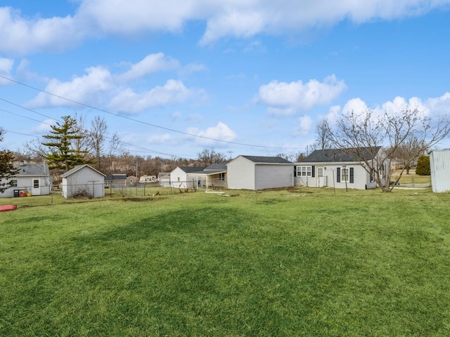 view of yard featuring an outdoor structure and fence