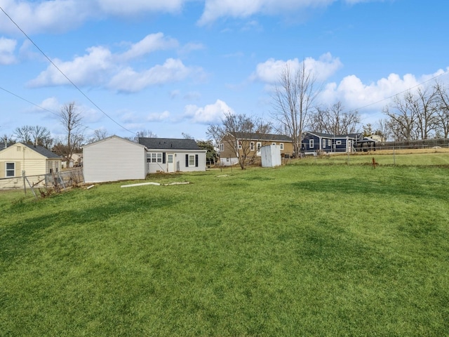 view of yard featuring an outdoor structure and fence