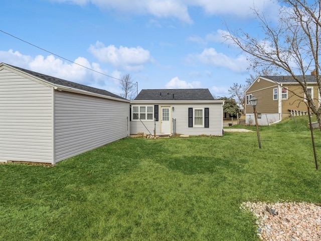 rear view of house with a lawn