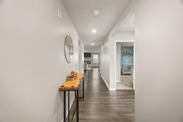 hall featuring recessed lighting, visible vents, baseboards, and dark wood-style flooring