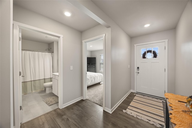 entryway with recessed lighting, baseboards, and dark wood-style flooring