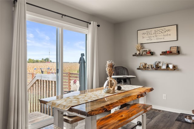 dining room with wood finished floors and baseboards