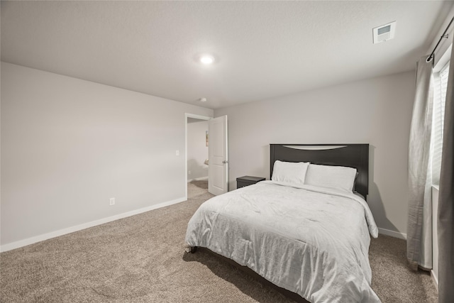 carpeted bedroom featuring visible vents and baseboards