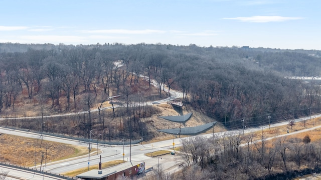 drone / aerial view with a wooded view