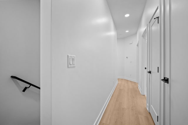 hall with recessed lighting, baseboards, and light wood-style floors