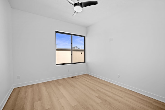 unfurnished room featuring baseboards, light wood-style flooring, and a ceiling fan