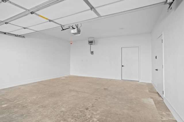 garage with a garage door opener and baseboards