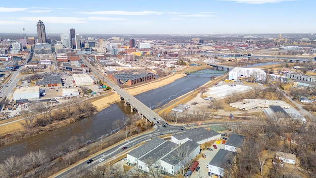 drone / aerial view featuring a city view and a water view