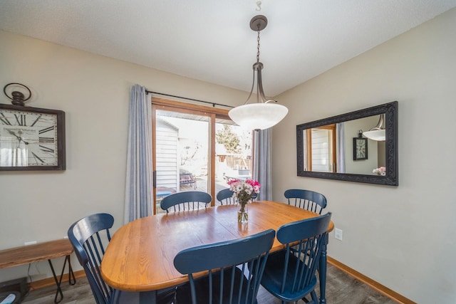 dining room featuring baseboards and wood finished floors