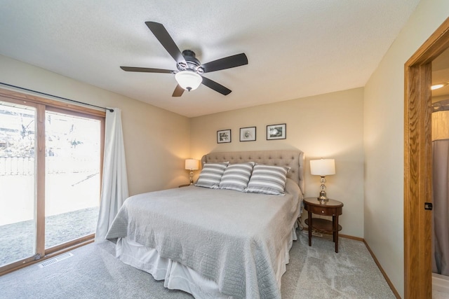 carpeted bedroom featuring a ceiling fan, access to outside, baseboards, and visible vents