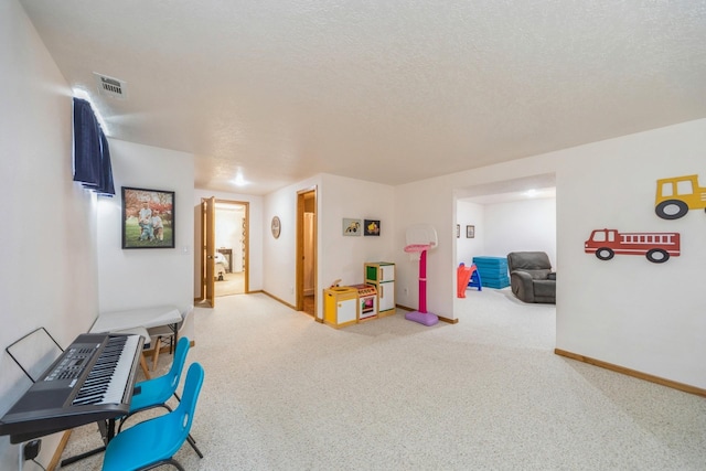 interior space featuring carpet flooring, visible vents, baseboards, and a textured ceiling