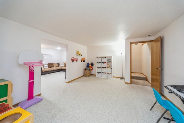 game room with carpet flooring, visible vents, and baseboards