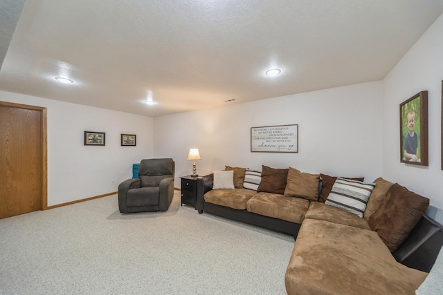 carpeted living area with recessed lighting and baseboards