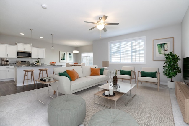 living area featuring recessed lighting and ceiling fan