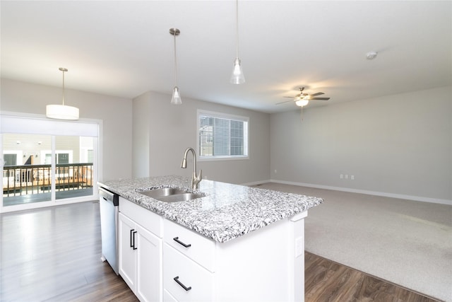 kitchen with ceiling fan, a sink, stainless steel dishwasher, decorative light fixtures, and open floor plan