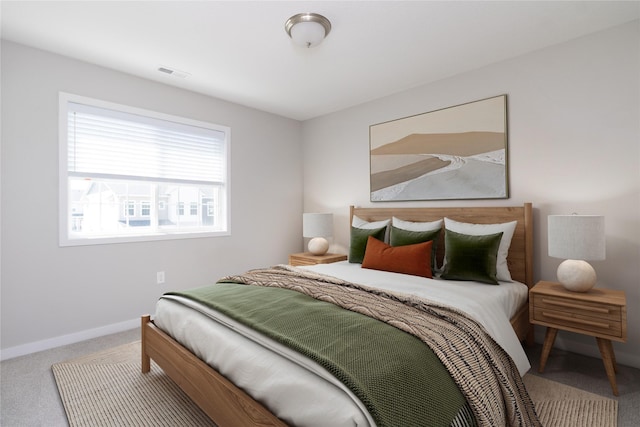 bedroom featuring visible vents, carpet flooring, and baseboards