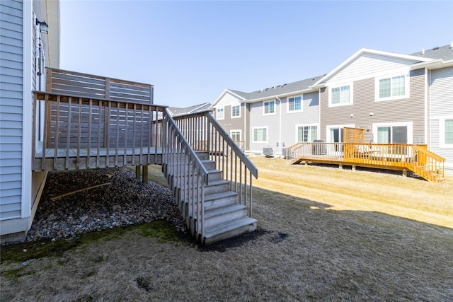 view of yard featuring stairs, cooling unit, a residential view, and a wooden deck