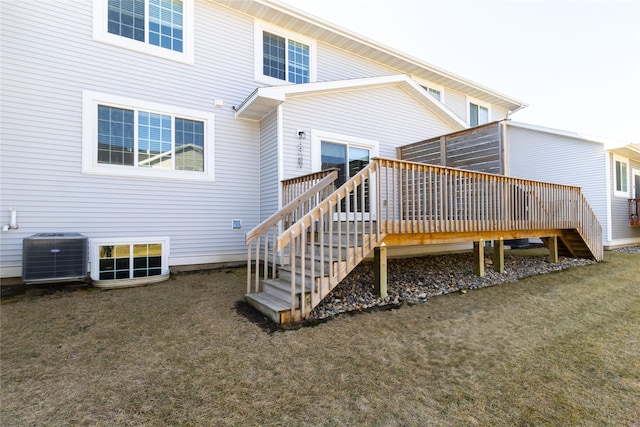 back of property with stairs, central air condition unit, a lawn, and a wooden deck