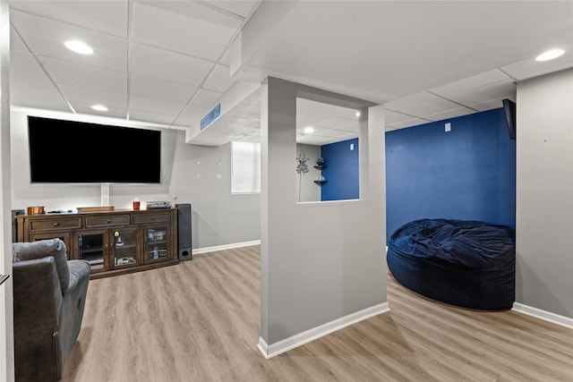 interior space featuring wood finished floors, baseboards, and a paneled ceiling