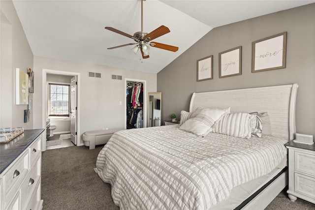 carpeted bedroom featuring a walk in closet, vaulted ceiling, visible vents, and a closet