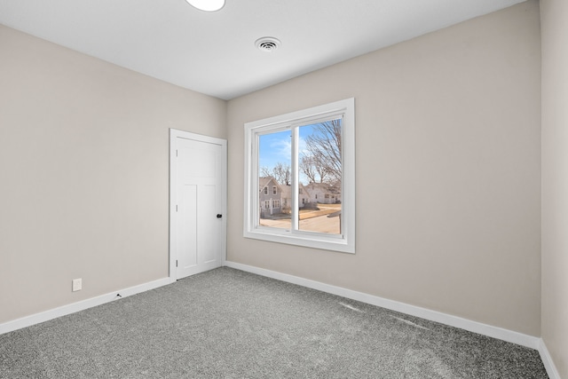 carpeted empty room with baseboards and visible vents