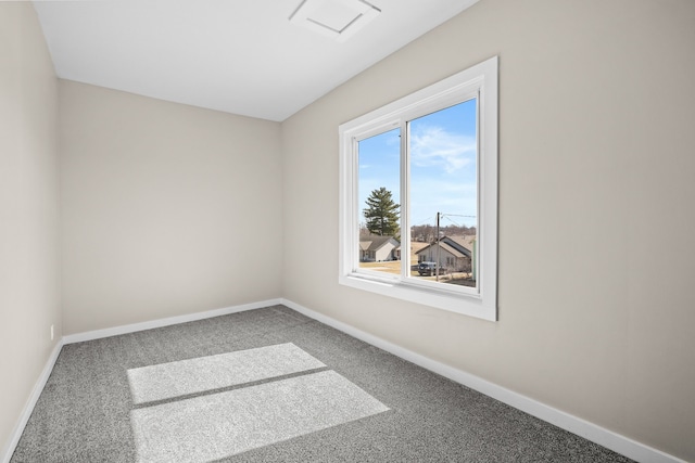 unfurnished room featuring baseboards and carpet