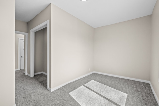 interior space featuring baseboards and carpet floors