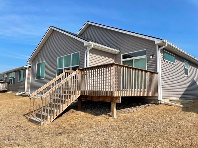 rear view of house featuring a deck