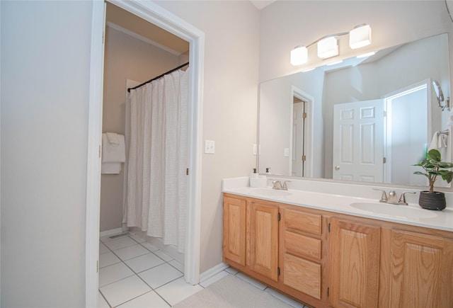 bathroom featuring tile patterned flooring, double vanity, a shower with curtain, and a sink