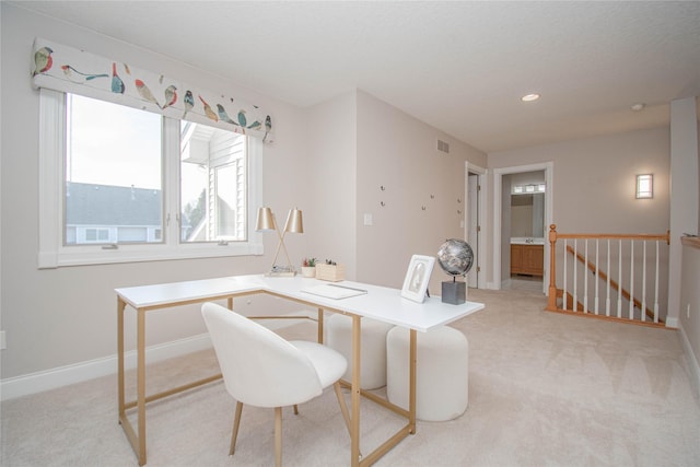 office space featuring light carpet, visible vents, recessed lighting, and baseboards