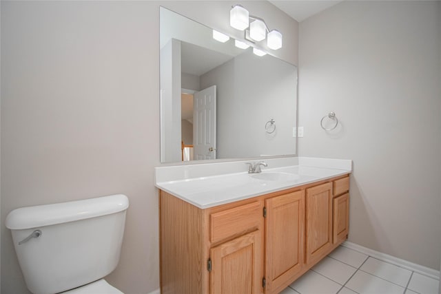 bathroom featuring tile patterned floors, toilet, vanity, and baseboards