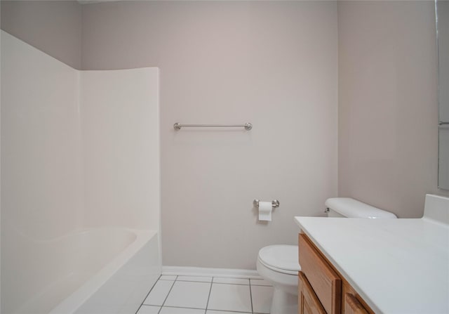 full bathroom featuring toilet, a bathing tub, tile patterned flooring, baseboards, and vanity