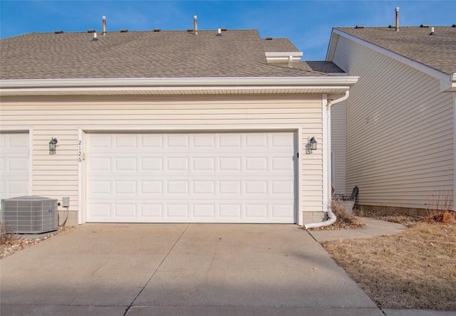 garage featuring driveway and central AC